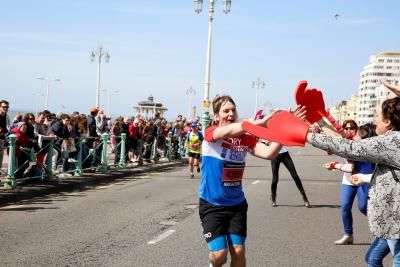 Teenage Cancer Trust Brighton Marathon runner being cheered on