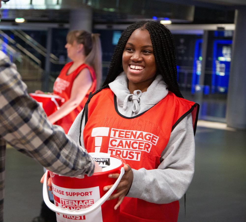 Young person volunteering at a bucket collection