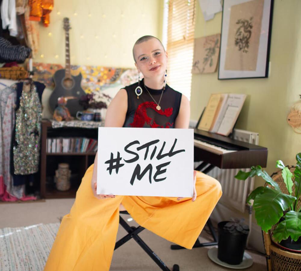 Holly holding a sign reading #StillMe