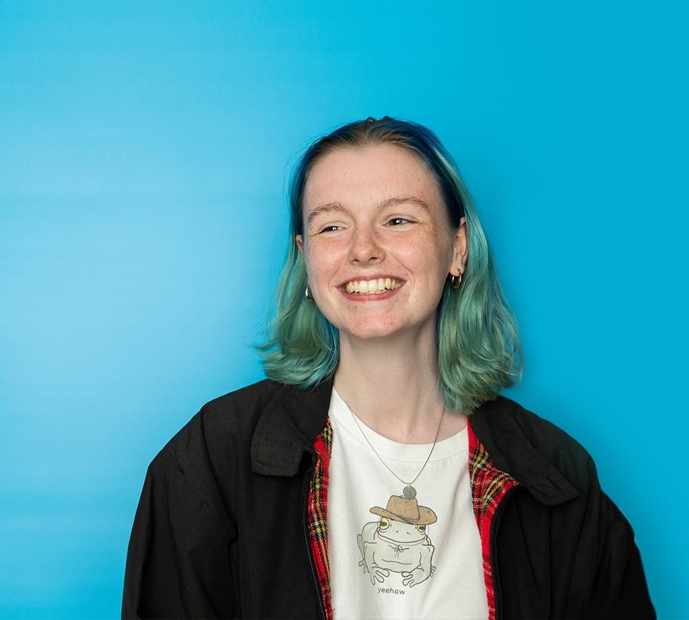 Young girl with blue hair on a blue background
