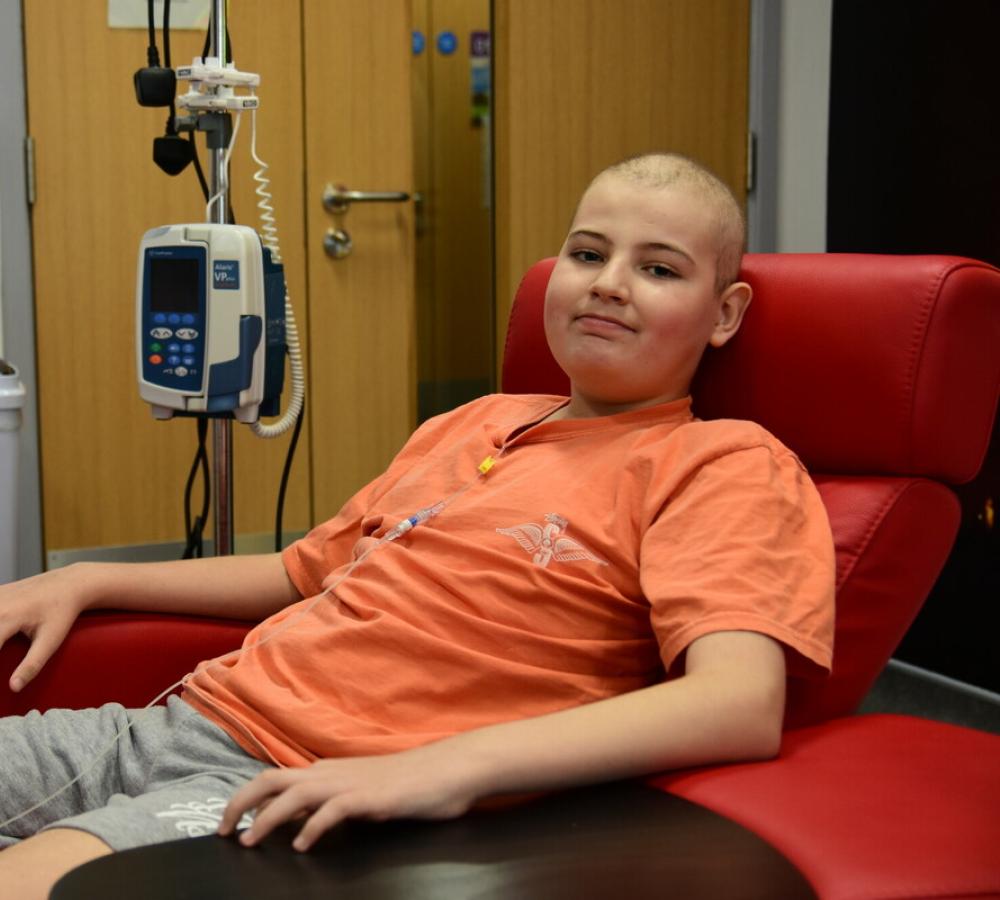 A young person with cancer in a Teenage Cancer Trust unit receiving treatment