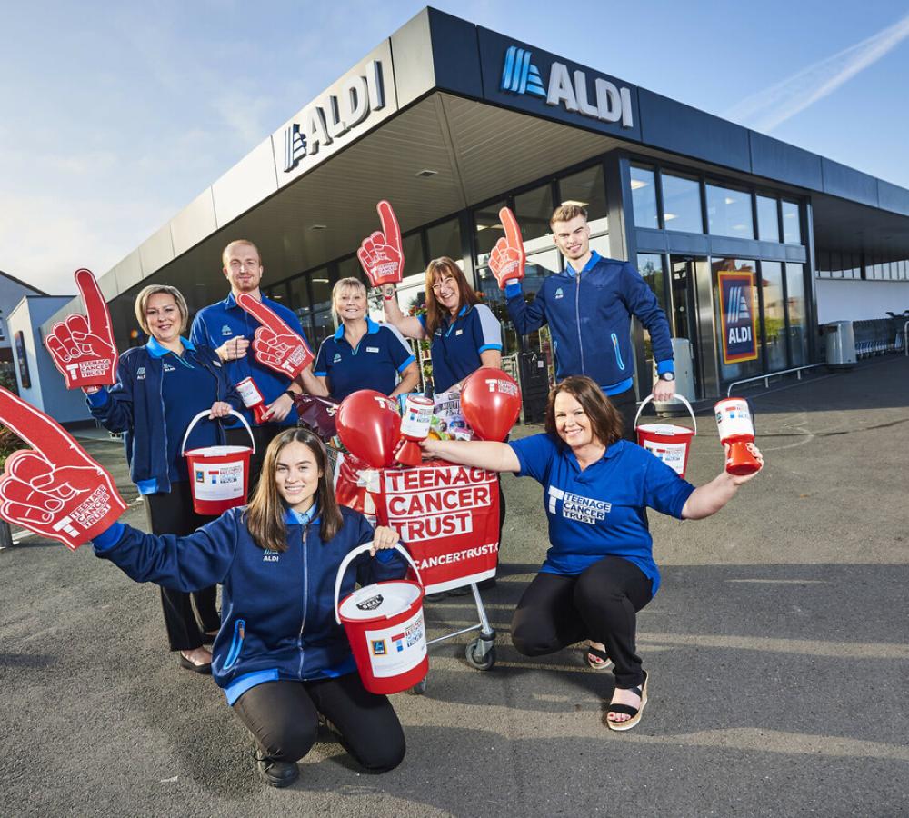 Group of Aldi employees ourside one of their stores, supporting Teenage Cancer Trust