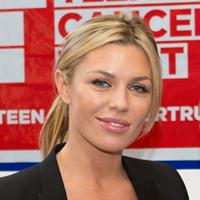 Abbey Clancy in front of a teenage cancer turst logo 