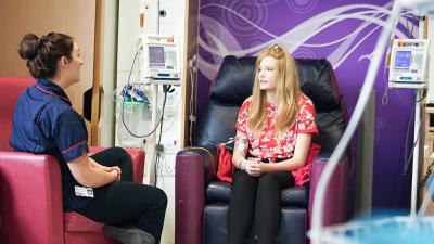 A young person talking with a Teenage Cancer Trust nurse