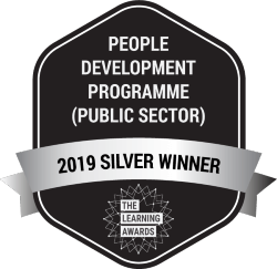 The Learning Awards logo: 2019 Silver Winner. People and Development Programme (Public Sector)