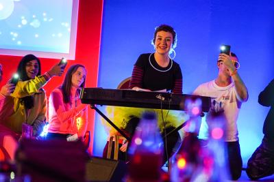 Young people on stage playing keyboard at FYSOT 2019 Over 18s