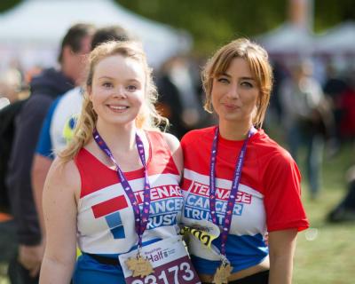 Two Teenage Cancer Trust runners post Royal Parks Half Marathon with their medals