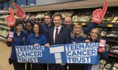 Aldi employees with a bit Teenage Cancer Trust banner