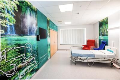 A single room with a TV and visitor seating at our Birmingham Children's Hospital unit