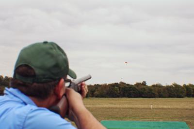 A man shooting a clay pigeon