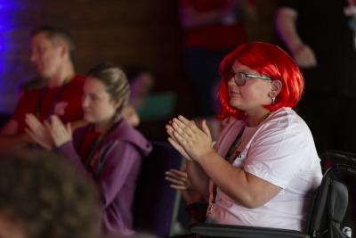 A young person clapping at Teenage Cancer Trust's event for young people who have had cancer Find Your Sense of Tumour