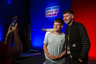 People posing for a photo at Teenage Cancer Trust's event for young people who have had cancer Find Your Sense of Tumour