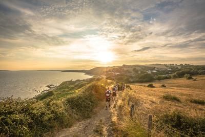 A group of walkers trekking along the Jurassic Coast as part of the Jurassic Coast Challenge