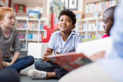 Children reading books in a read-a-thon for Teenage Cancer Trust
