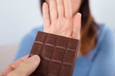 A person refusing a block of chocolate because they are giving up chocolate to raise money for Teenage Cancer Trust