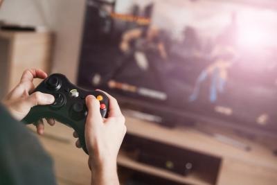 A fundraiser playing a videogame to raise money for Teenage Cancer Trust with a sponsored Game-a-thon
