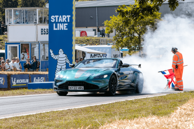 An Aston Martin setting off from the start line at the racetrack at CarFest
