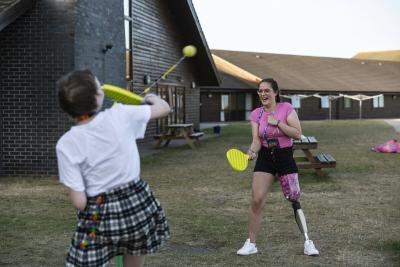 Two young people taking on cancer and exercise with a game of swing ball