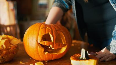 Somebody carving a Halloween pumpkin to raise money for Teenage Cancer Trust