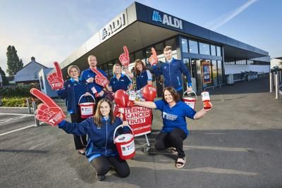 Group of Aldi employees ourside one of their stores, supporting Teenage Cancer Trust