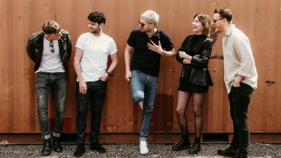 The Courteeners, standing against a fence - to perform at Teenage Cancer Trust Gigs, Royal Albert Hall 2023