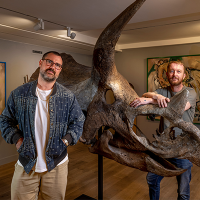 Connor Brothers standing next to a large animal skull