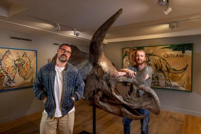 Connor Brothers, Teenage Cancer Trust ambassadors, standing next to a large animal skull