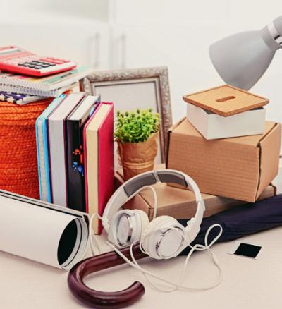 Household items including books, headphones and an umbrella