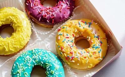 A box of doughnuts with sprinkles