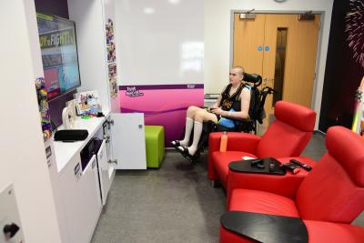 Aidan, a young person with cancer, on a Teenage Cancer Trust ward gaming for charity