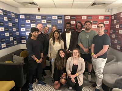 Romesh Ranganathan, on set at A league of their own, with a group of young people with cancer