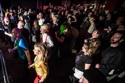 A crowd of people looking at a stage and dancing