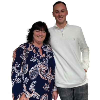 A man with his arm around a woman smiling