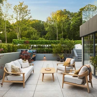 The outdoor area at the New Forest house, including sofas and potted acer and ferns