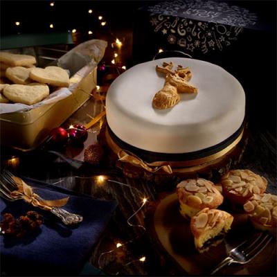 A table of Christmas desserts, including cakes and biscuits from Meg Rivers Bakery