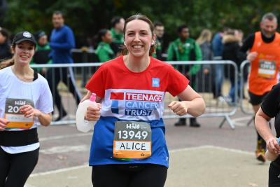 Teenage Cancer Trust runner smiles to the camera while running the Royal Parks Half Marathon