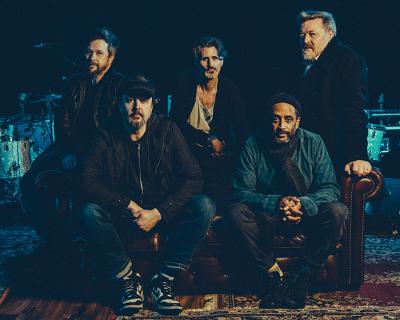 The band Elbow sitting on a sofa