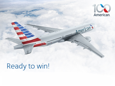 An American Airlines plane with a red, white, and blue tail design flies above the clouds. The American Airlines 100th anniversary logo is in the top right corner. Text at the bottom reads, Ready to win!.