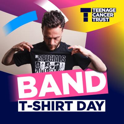 Person holding out a black band T-shirt as part of Teenage Cancer Trust’s Band T-Shirt Day campaign, with colourful graphics.