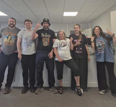 Supporters holding band t-shirt day